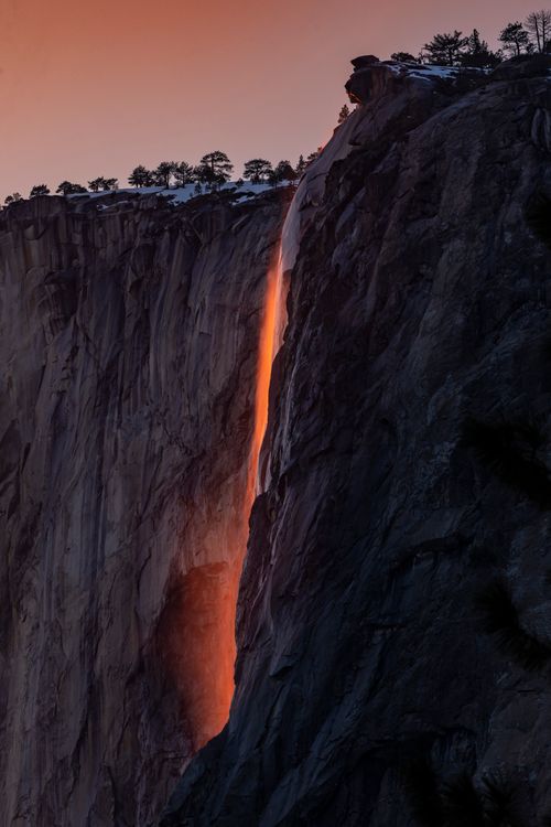 Free Spectacular view of the glowing waterfall near the cliff at sunset in Yosemite National Park. Stock Photo