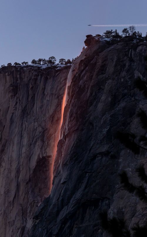 Free Stunning twilight capture of Yosemite's Horsetail Fall, glowing with fiery hues on El Capitan in winter. Stock Photo