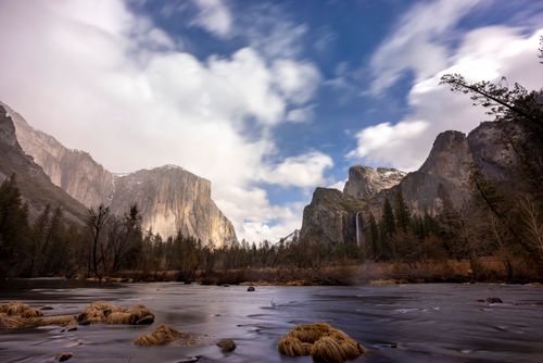 Free Breathtaking view of Yosemite Valley with El Capitan and waterfalls under a dynamic sky. Stock Photo
