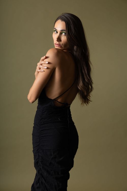 Free Striking portrait of a young woman in a black dress, exuding elegance and sophistication. Stock Photo