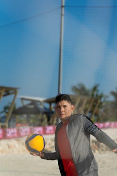 A young man enjoying a day of beach volleyball in sunny Progreso, Mexico.