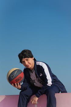 A young man holding a basketball enjoys a sunny day in Progreso, Mexico.