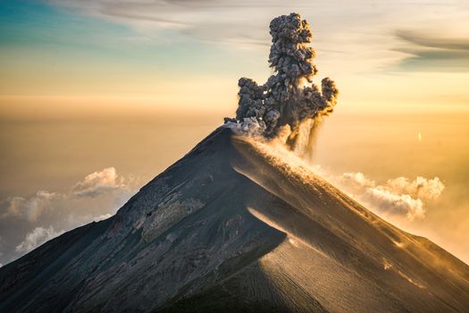 A volcano erupts with smoke and steam
