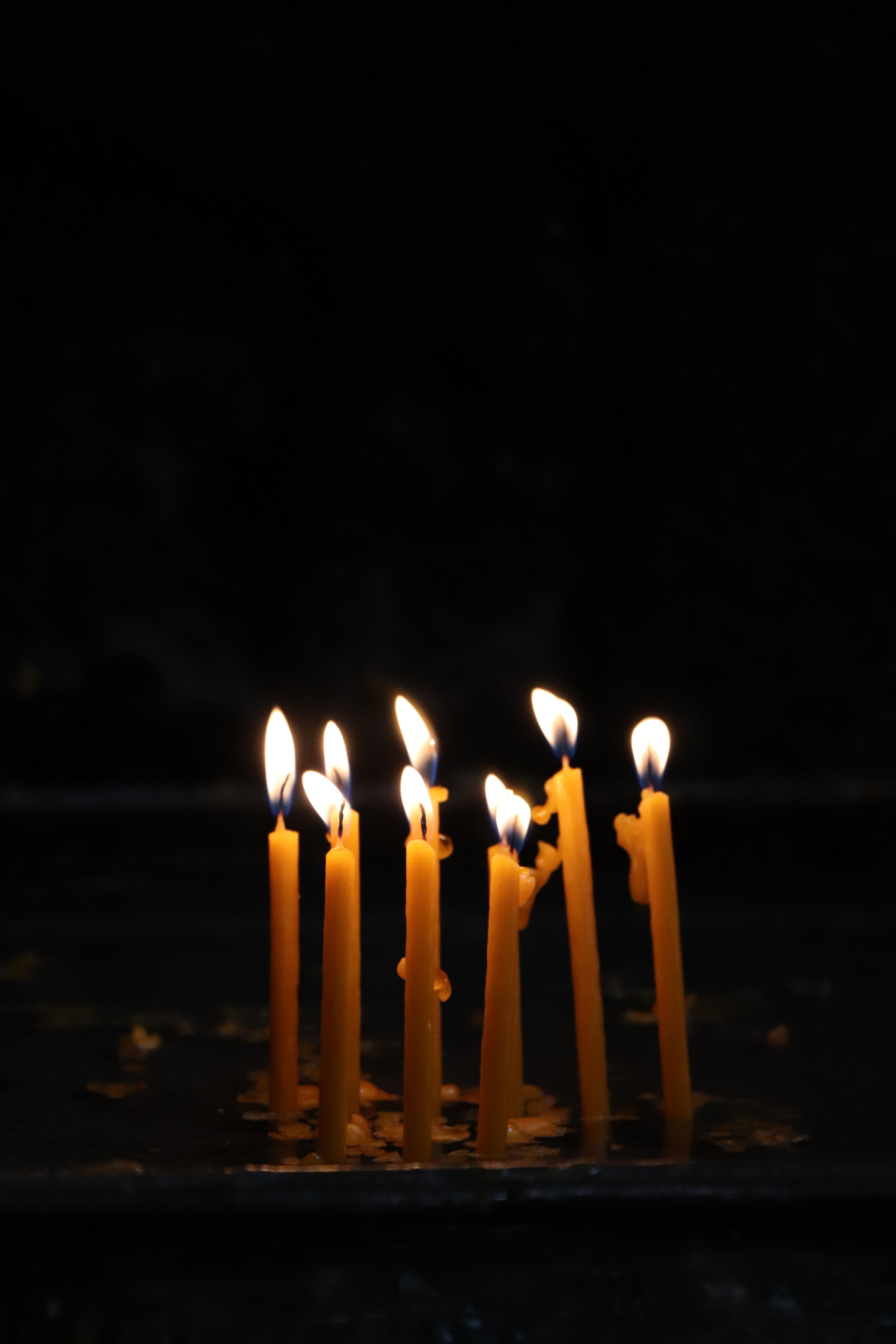 Candles lit in a dark room · Free Stock Photo