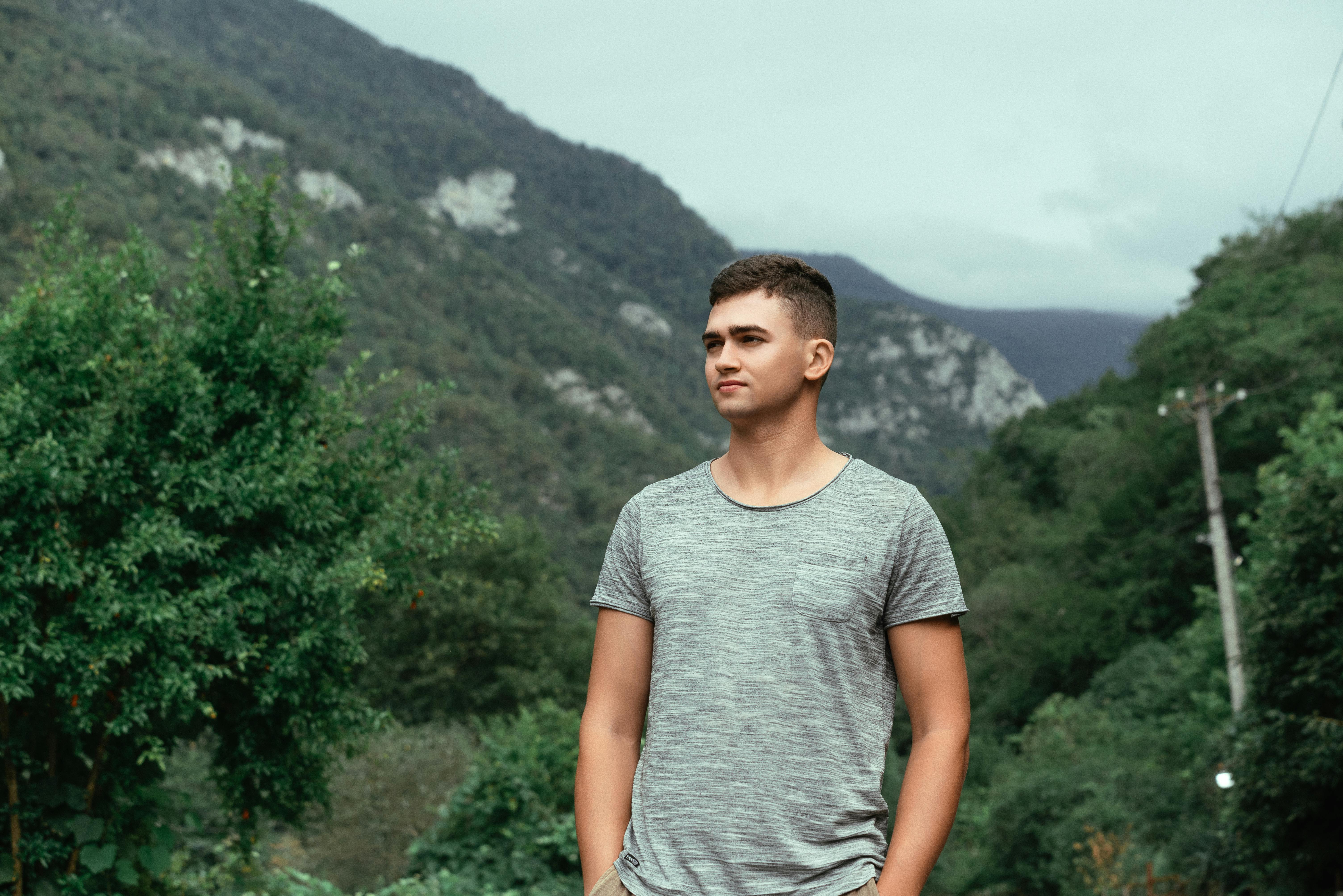 a man standing in front of a mountain range