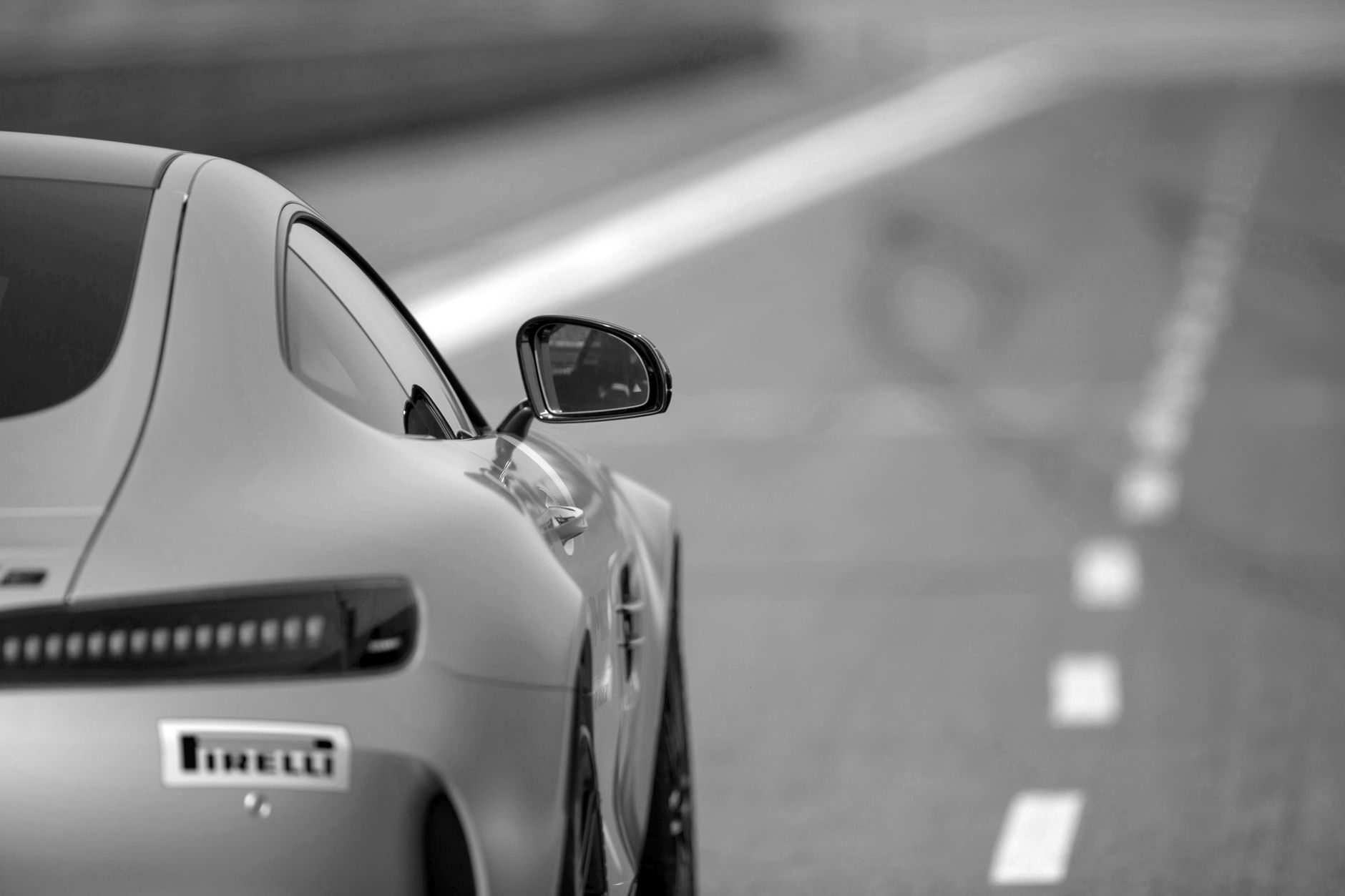 Monochrome shot of a Mercedes-Benz showcasing elegance and speed on a Berlin road.