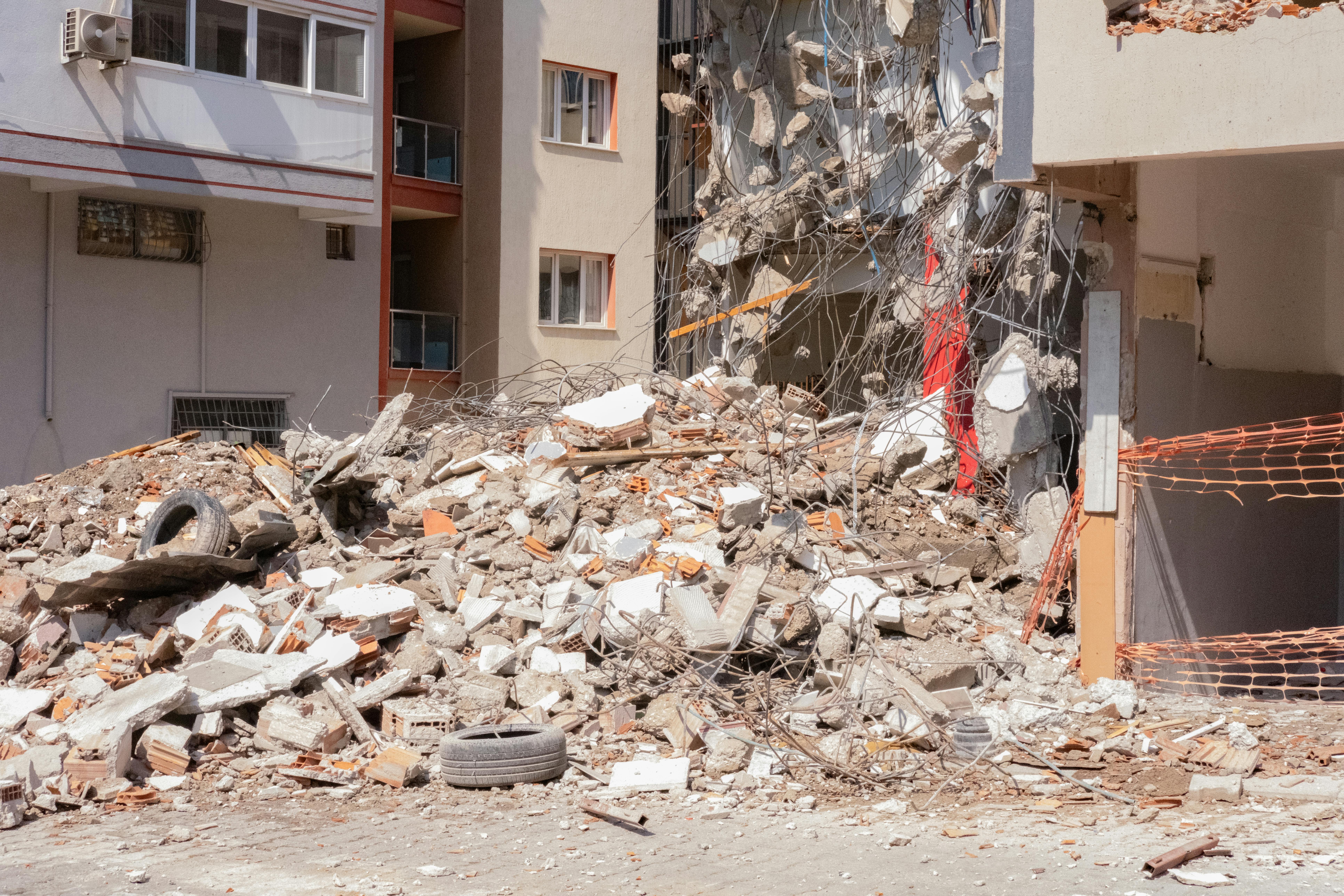 a building is being demolished by a crane