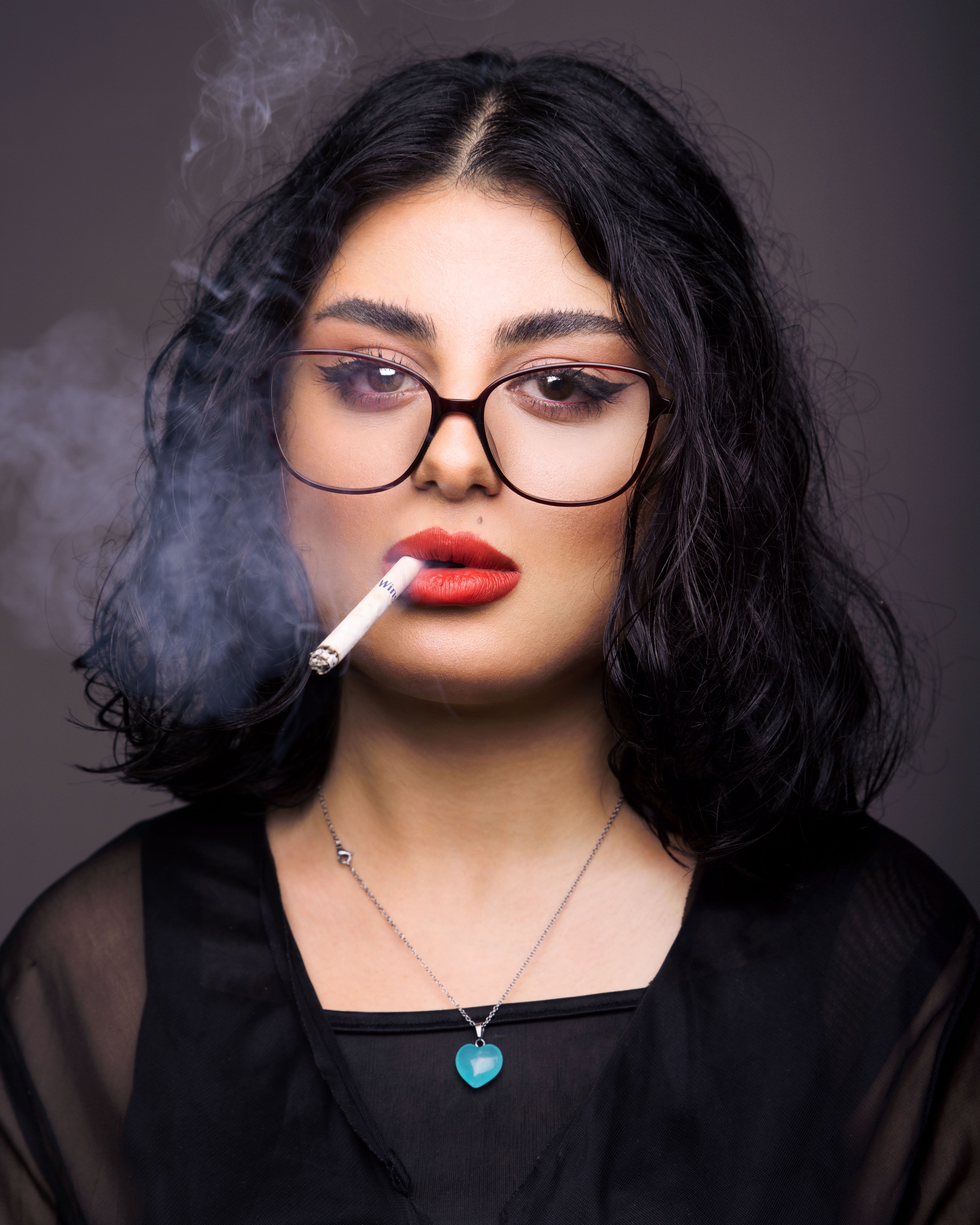 A woman with glasses and a cigarette · Free Stock Photo