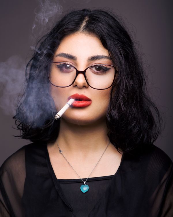 A woman with glasses and a cigarette · Free Stock Photo