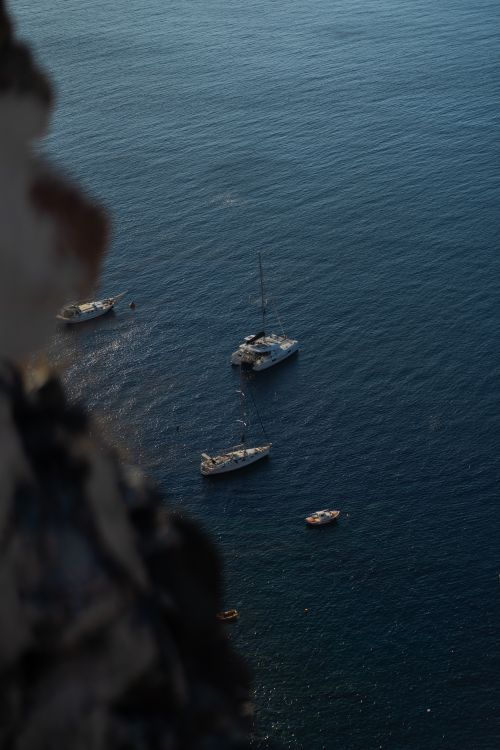 Free Aerial view of boats anchored in tranquil ocean waters, ideal for travel or relaxation themes. Stock Photo