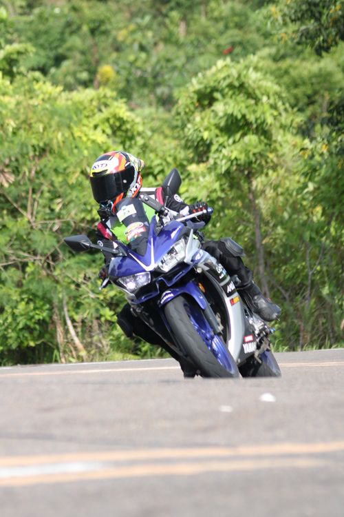 Free Motorcyclist speeds around a curve, showcasing skill and precision in a thrilling race. Stock Photo