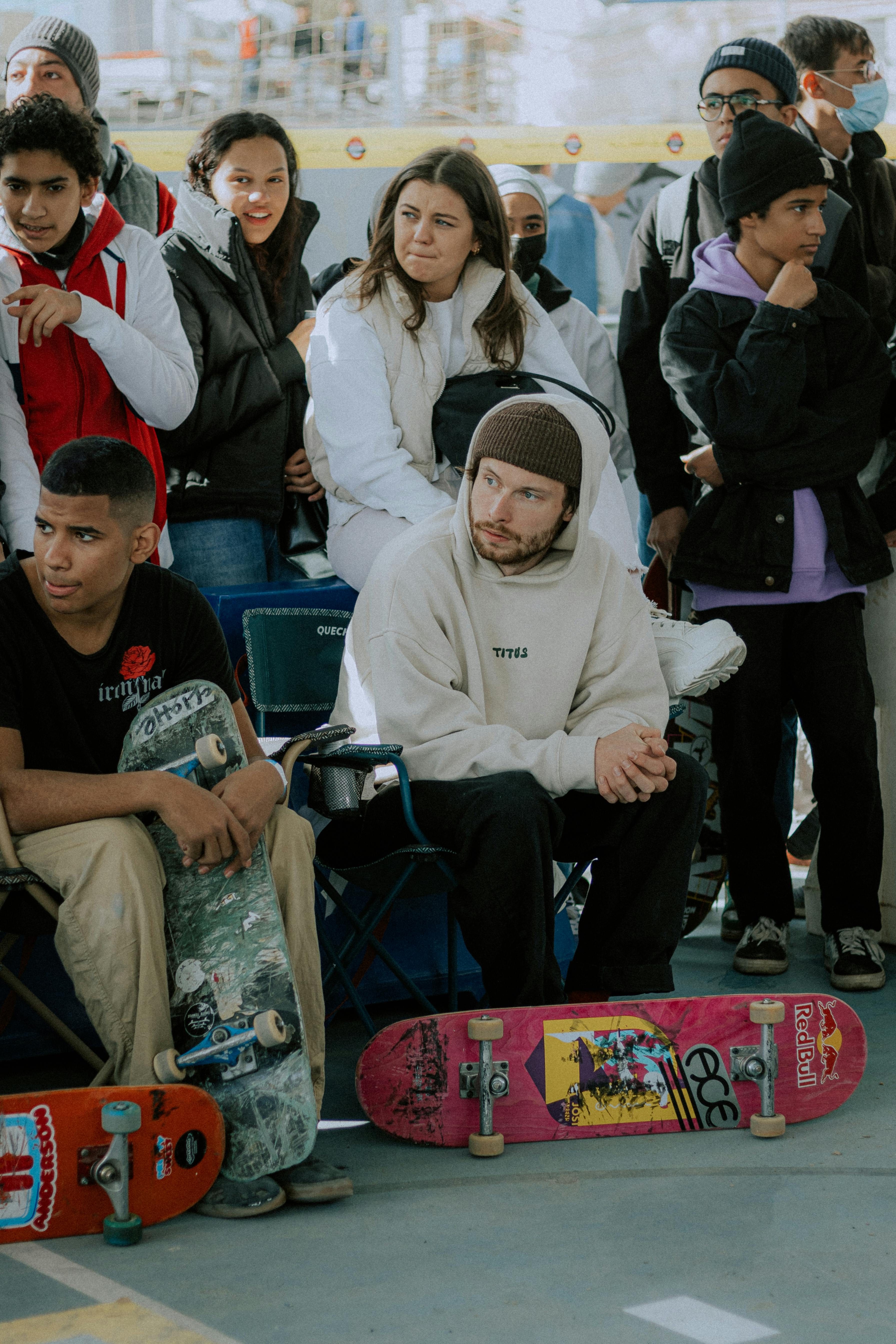 a group of people sitting in chairs with skateboards