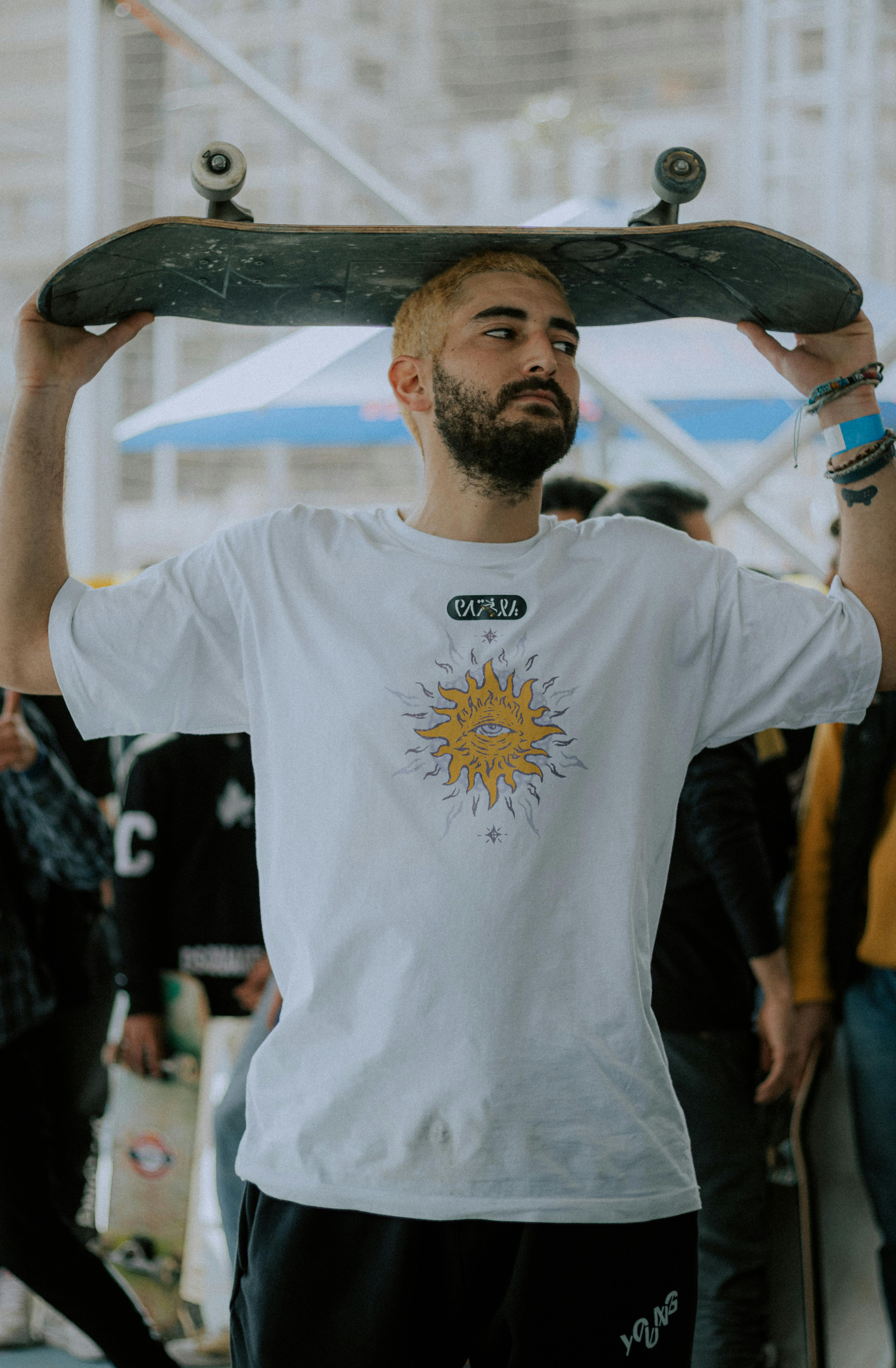 a man holding a skateboard on his head