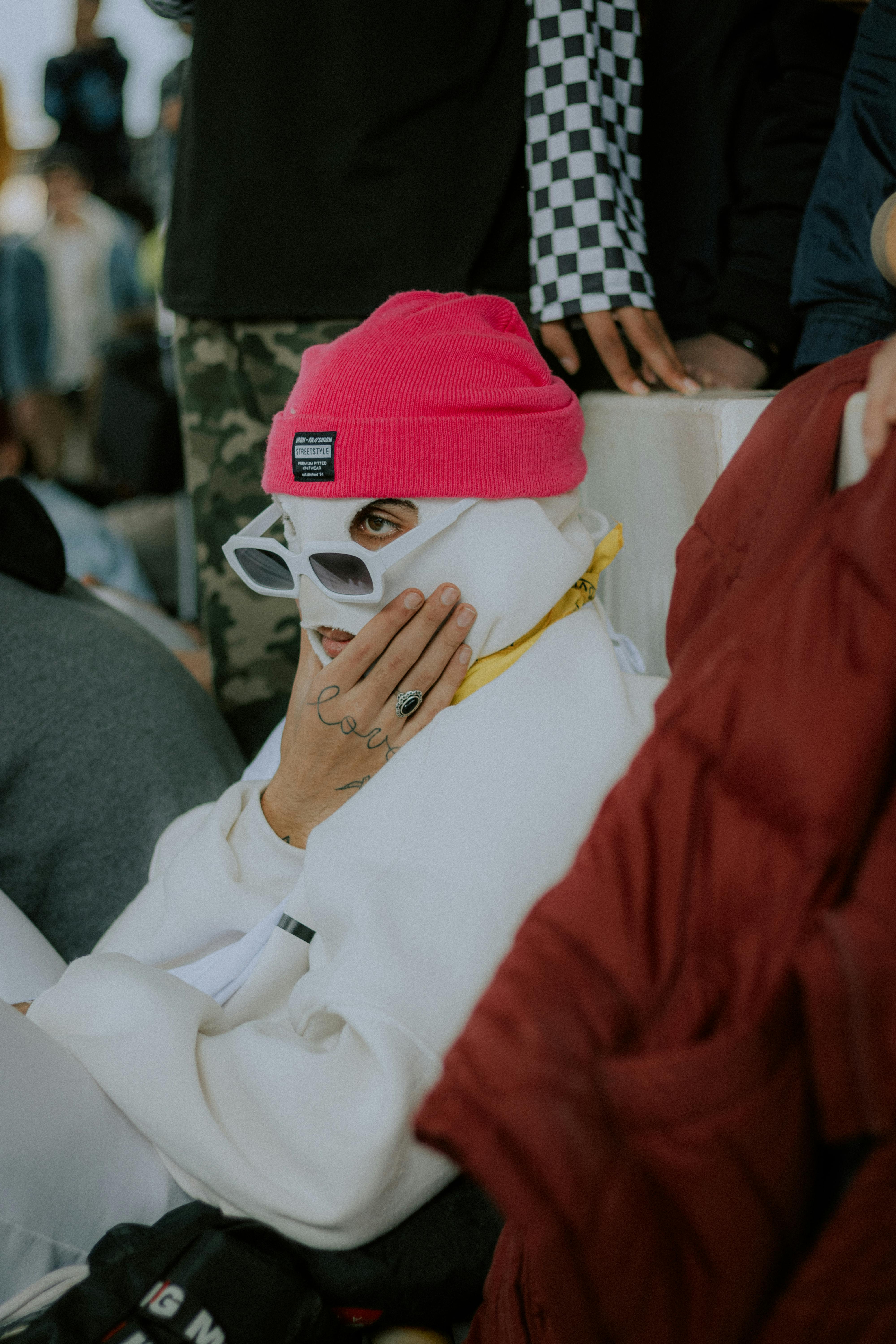 a person wearing a pink hat and white jacket