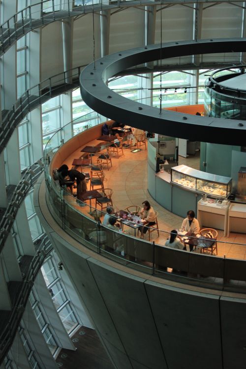 Free Elegant circular atrium with café seating and modern architecture indoors. Stock Photo