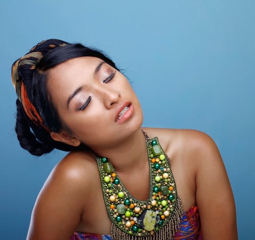 Woman Wearing Bib Necklace And Strapless Top