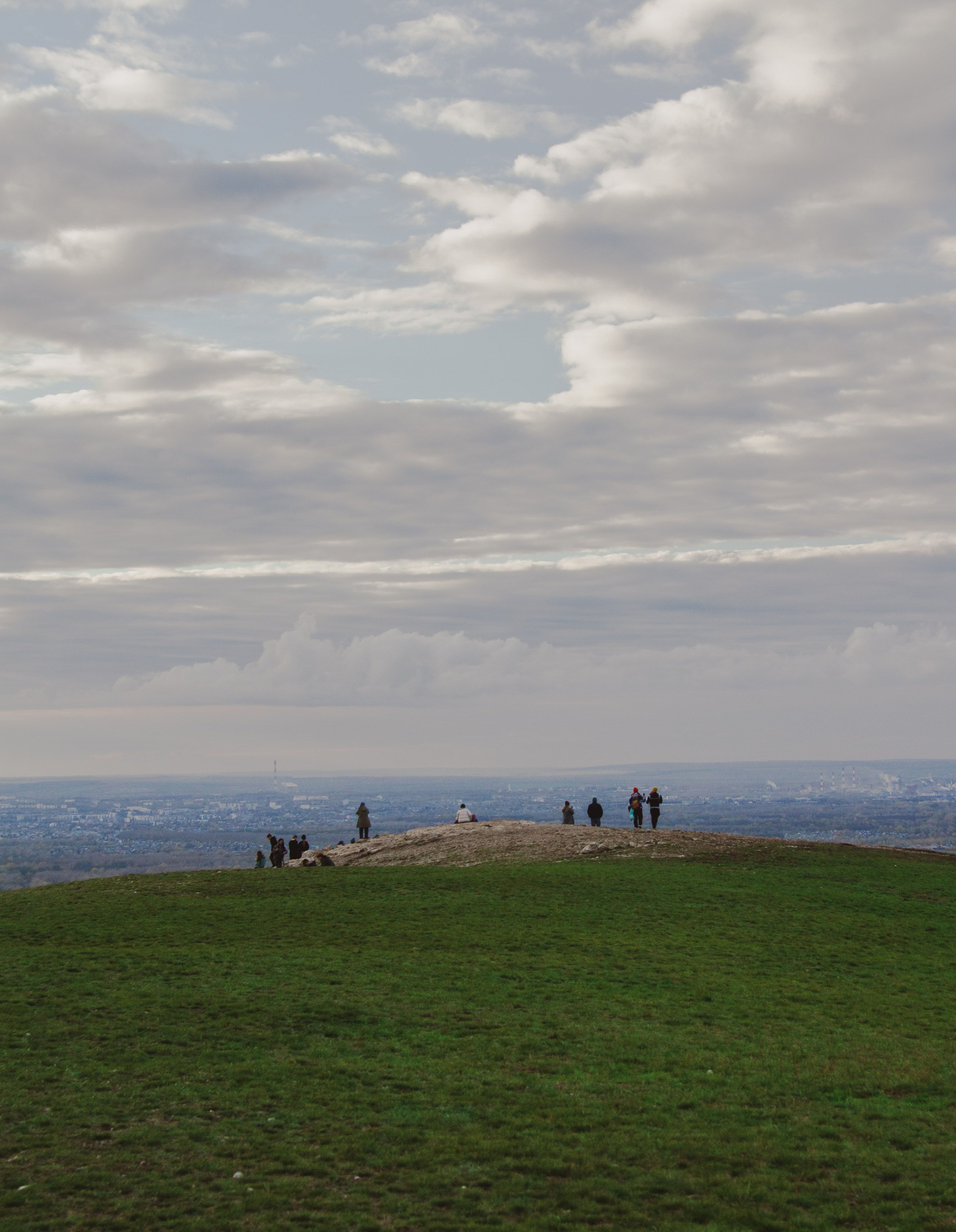 A group of people standing on top of a hill · Free Stock Photo