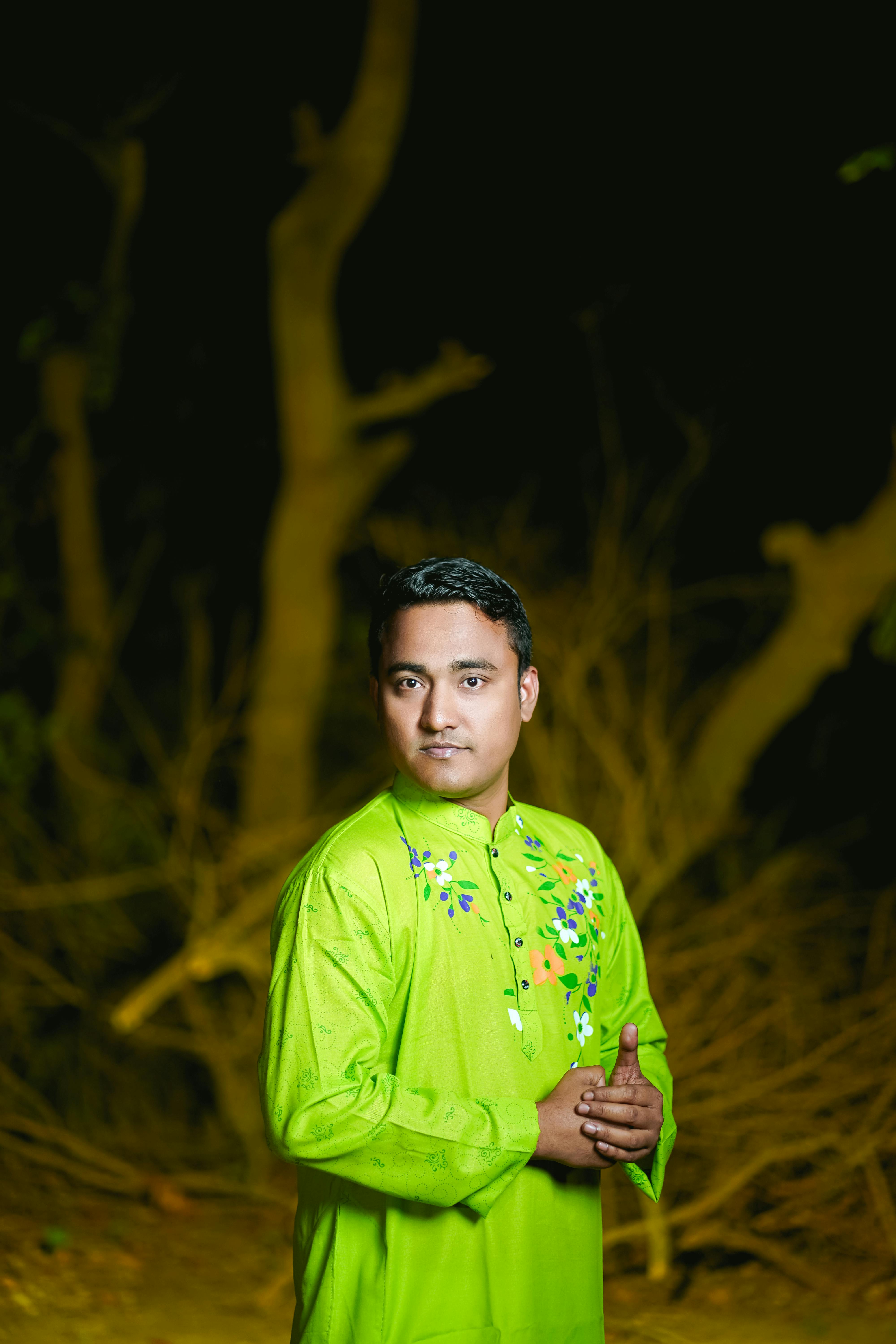 Vibrant portrait of a man in traditional Bangladeshi attire set against a natural background. Perfect for cultural themes.