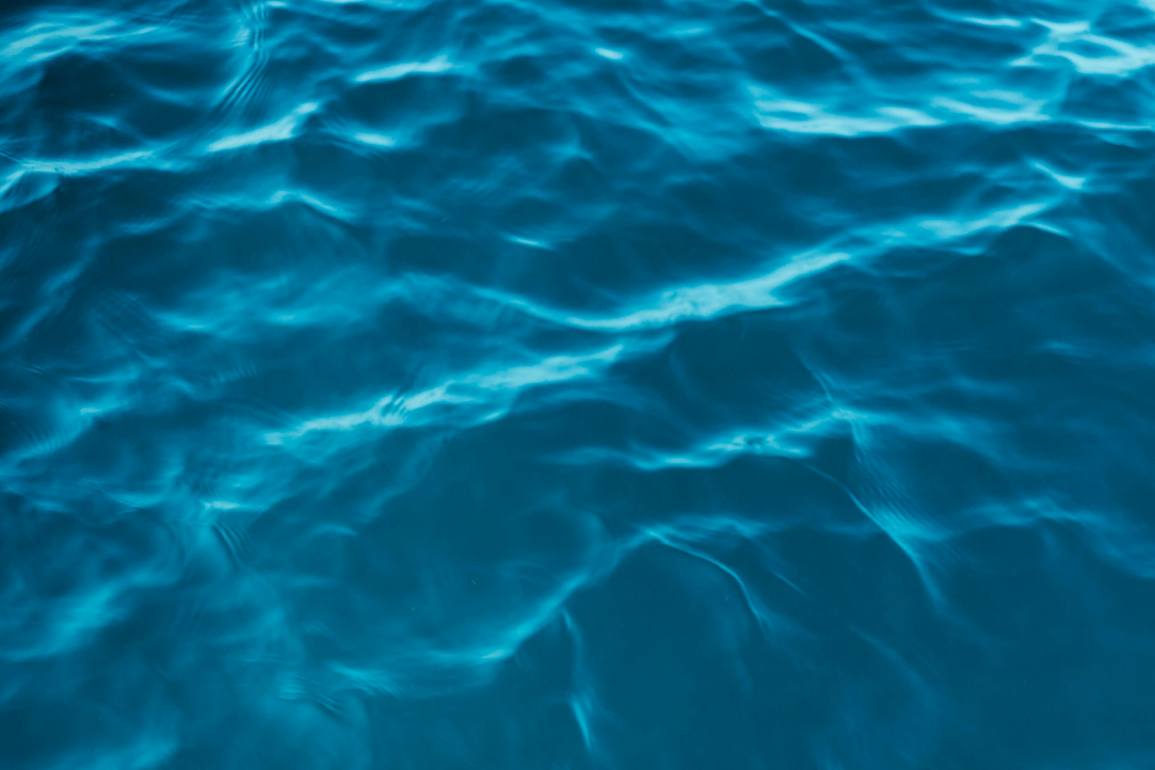 Vivid turquoise waves create an abstract, calming background perfect for wallpapers.
