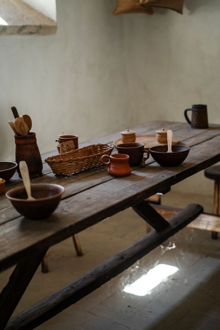 Rustic dining table set with ceramic tableware — photo by Olena Bohovyk on Pexels