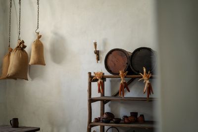 Rustic kitchen with wooden shelves and hanging pans — Olena Bohovyk on Pexels