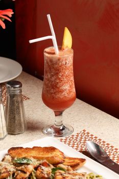Vibrant fruit smoothie served alongside grilled chicken with toast, capturing a healthy meal setup.