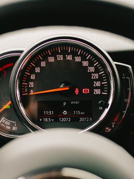 Close-up of a car speedometer showing speed and mileage with distinct displays.