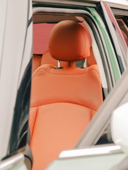 Close-up of a luxurious orange car seat in a contemporary vehicle, highlighting comfort and style.