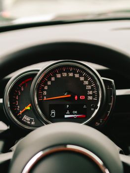 Detailed photo of a car dashboard, showing speedometer and various gauges.