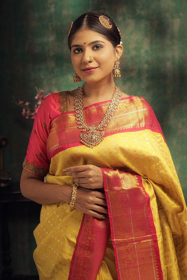 Elegant Indian woman in gold-jewelled saree by Royal Glow Beauty Makeover