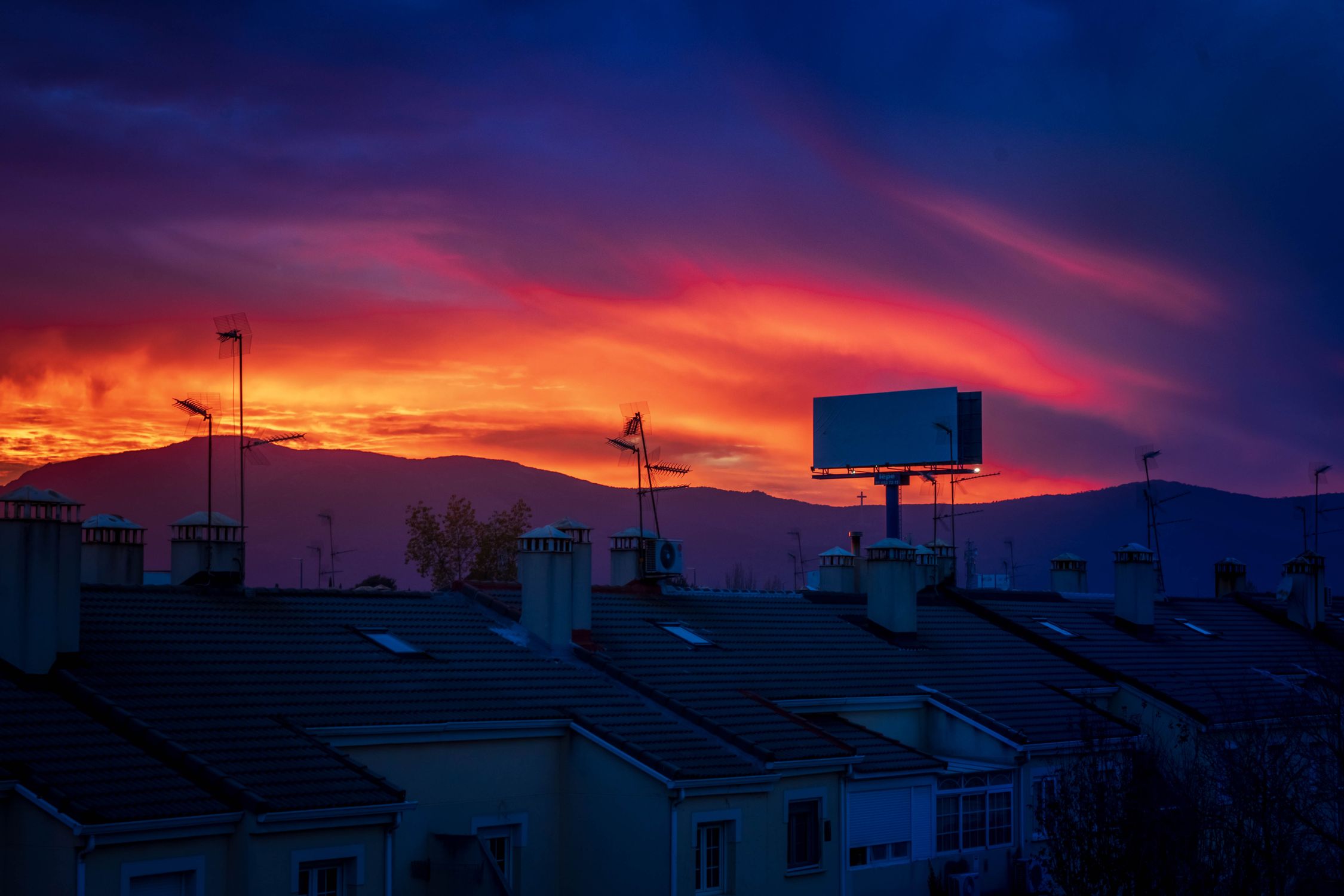 A sky with a colorful sunset over a city · Free Stock Photo