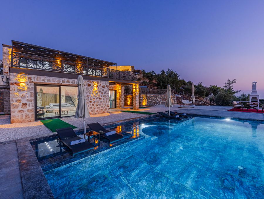 Landscape lighting install — pool and palms at dusk