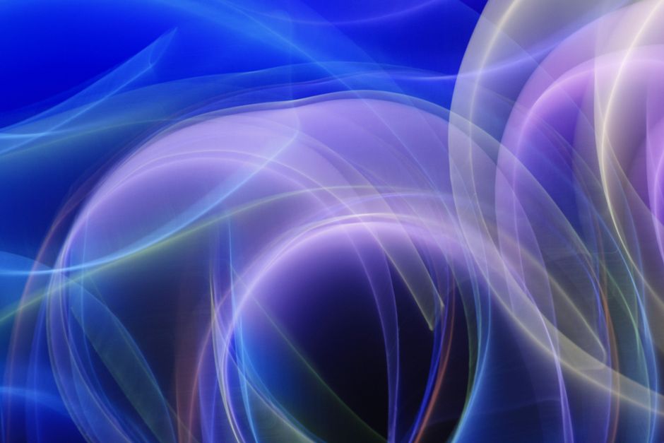 Dynamic abstract design featuring flowing light waves in blue and purple hues.