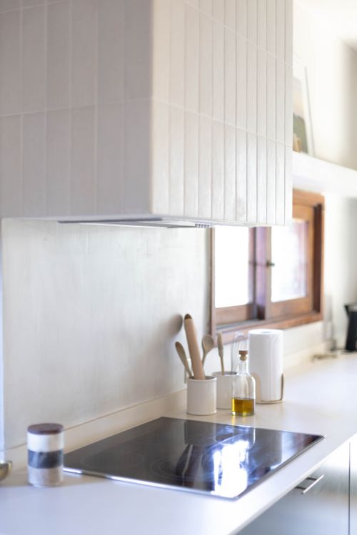 Free A contemporary kitchen with a sleek minimalist design featuring stainless steel appliances and natural light. Stock Photo