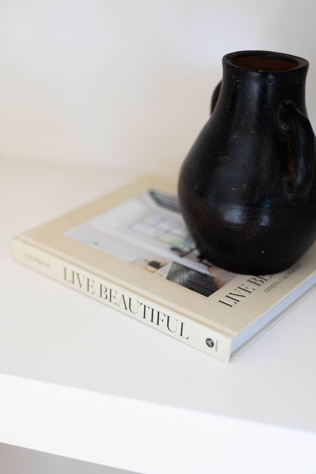 Handmade black clay pot with a simple rounded shape on a table