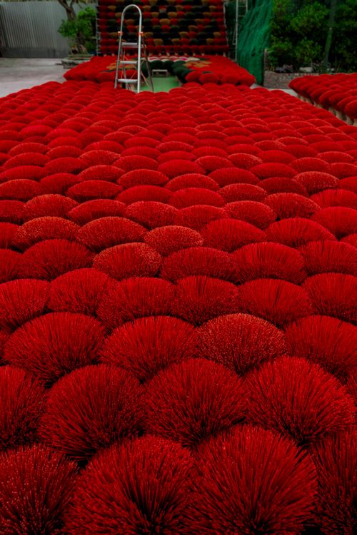 Free A visually striking display of red incense sticks drying outdoors in a traditional arrangement. Stock Photo