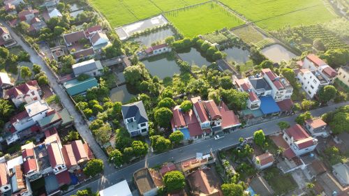 Free Scenic aerial shot of a lush Vietnamese village with greenery and water bodies. Stock Photo