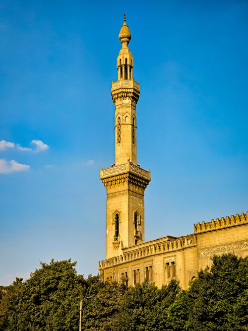 Free A stunning view of an ancient minaret under a bright blue sky, showcasing Islamic architecture. Stock Photo