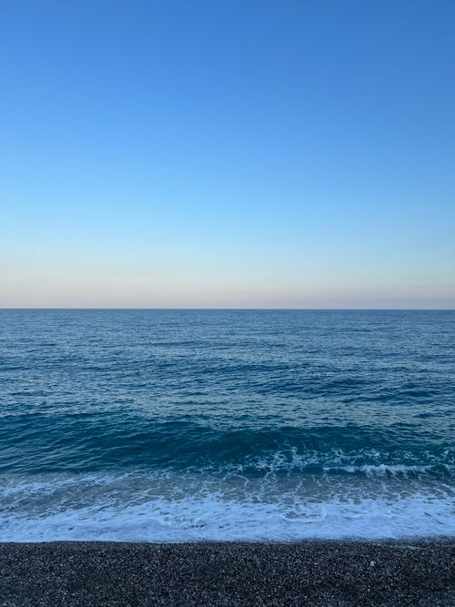 Free Peaceful seascape with gentle waves under a serene sky, ideal for relaxation themes. Stock Photo