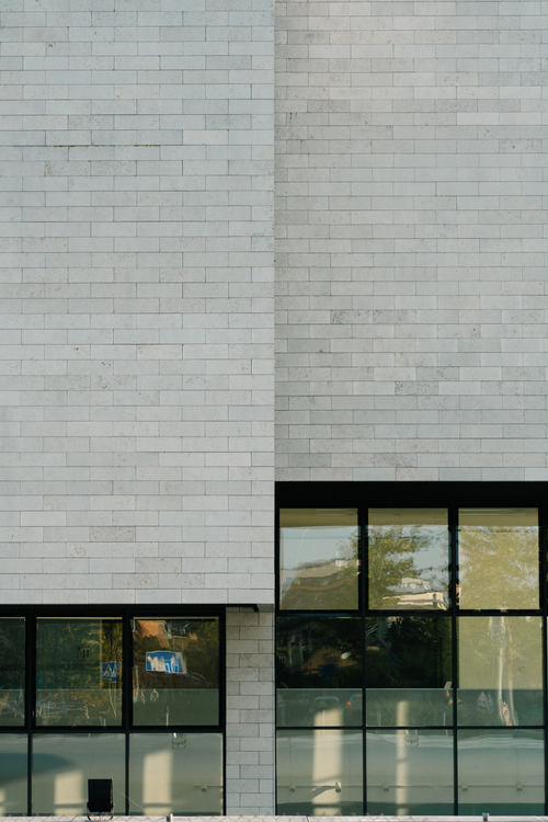 Free Modern building facade in Vilnius with brick pattern and reflective windows. Stock Photo