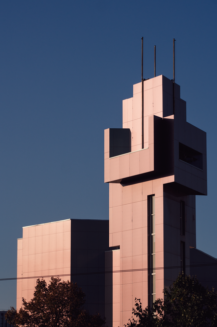 Striking modern building in Vilnius, Lithuania, highlighted by the sunset.