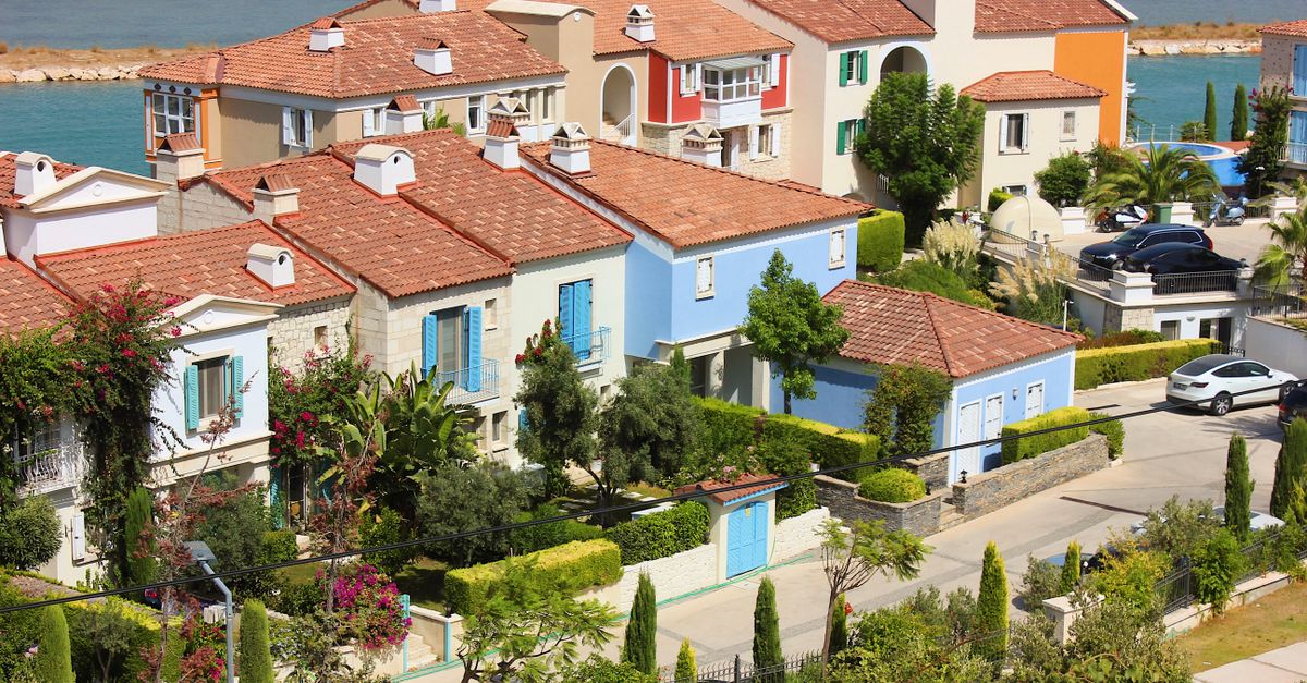 Charming row of vibrant Mediterranean-style houses by the sea, perfect for a serene coastal vacation.
