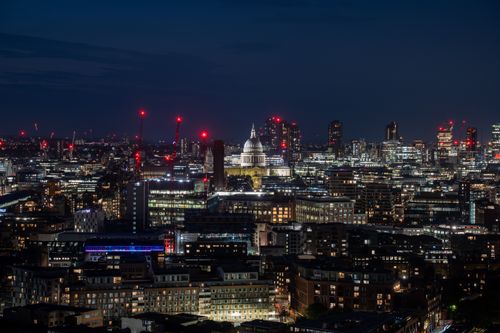 Free Beautiful nighttime view of London's skyline with St. Paul's Cathedral illuminated among city lights. Stock Photo