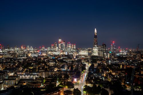 Free Capture a mesmerizing view of London's skyline featuring The Shard and skyscrapers illuminated at night. Stock Photo