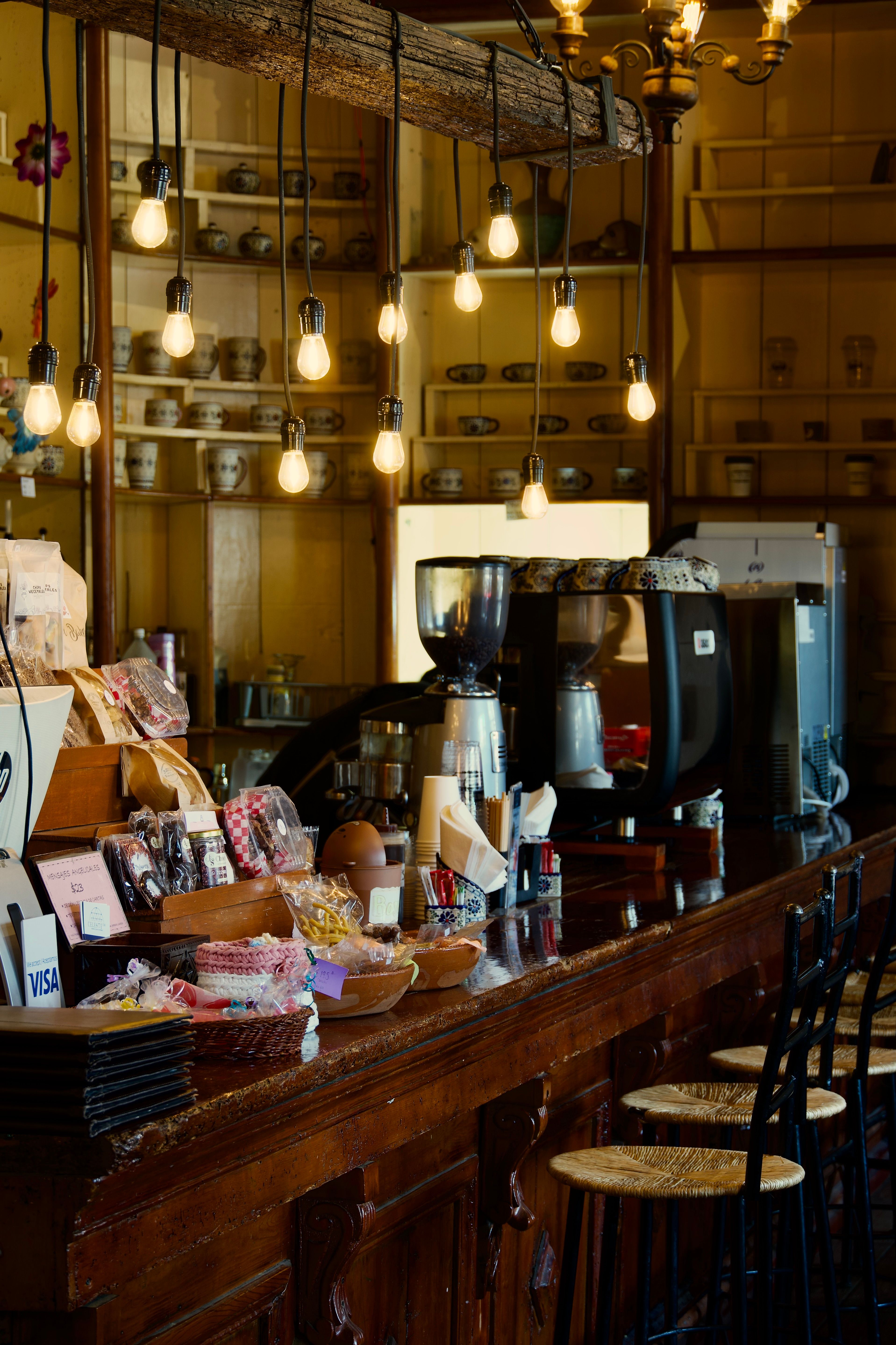 Smart color changing LED bulbs in a pendant light above a modern home coffee bar