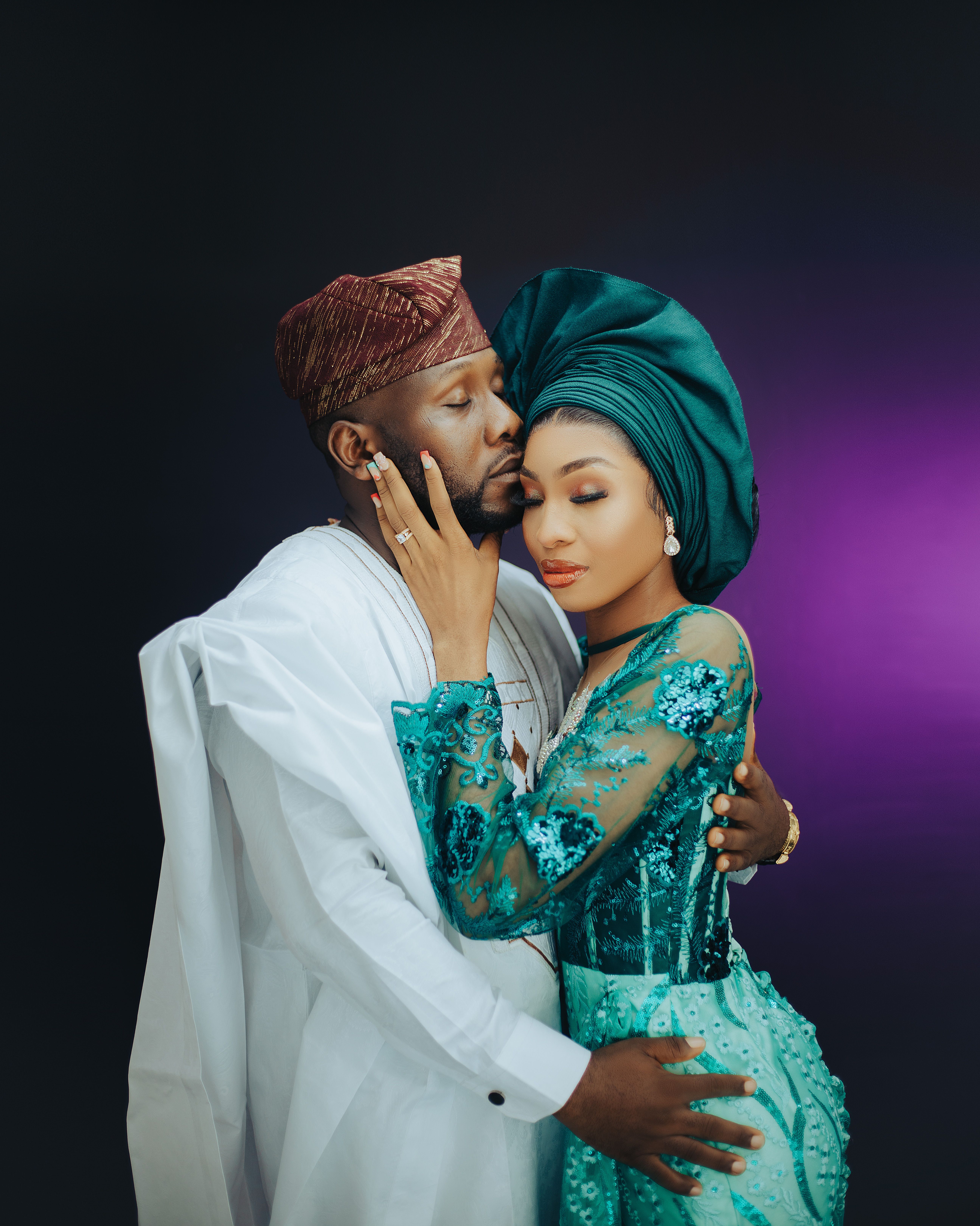 A couple in traditional attire hugging each other · Free Stock Photo