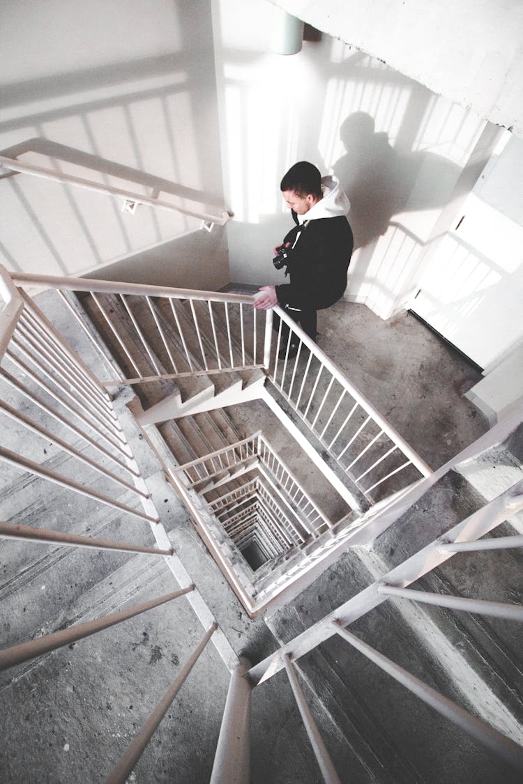 Man Walking On Spiral Stairs