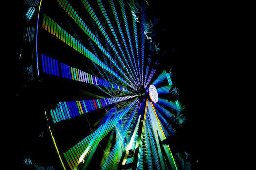 Captivating shot of Ferris wheel light trails creating a stunning pattern at night in Cairns, Australia.