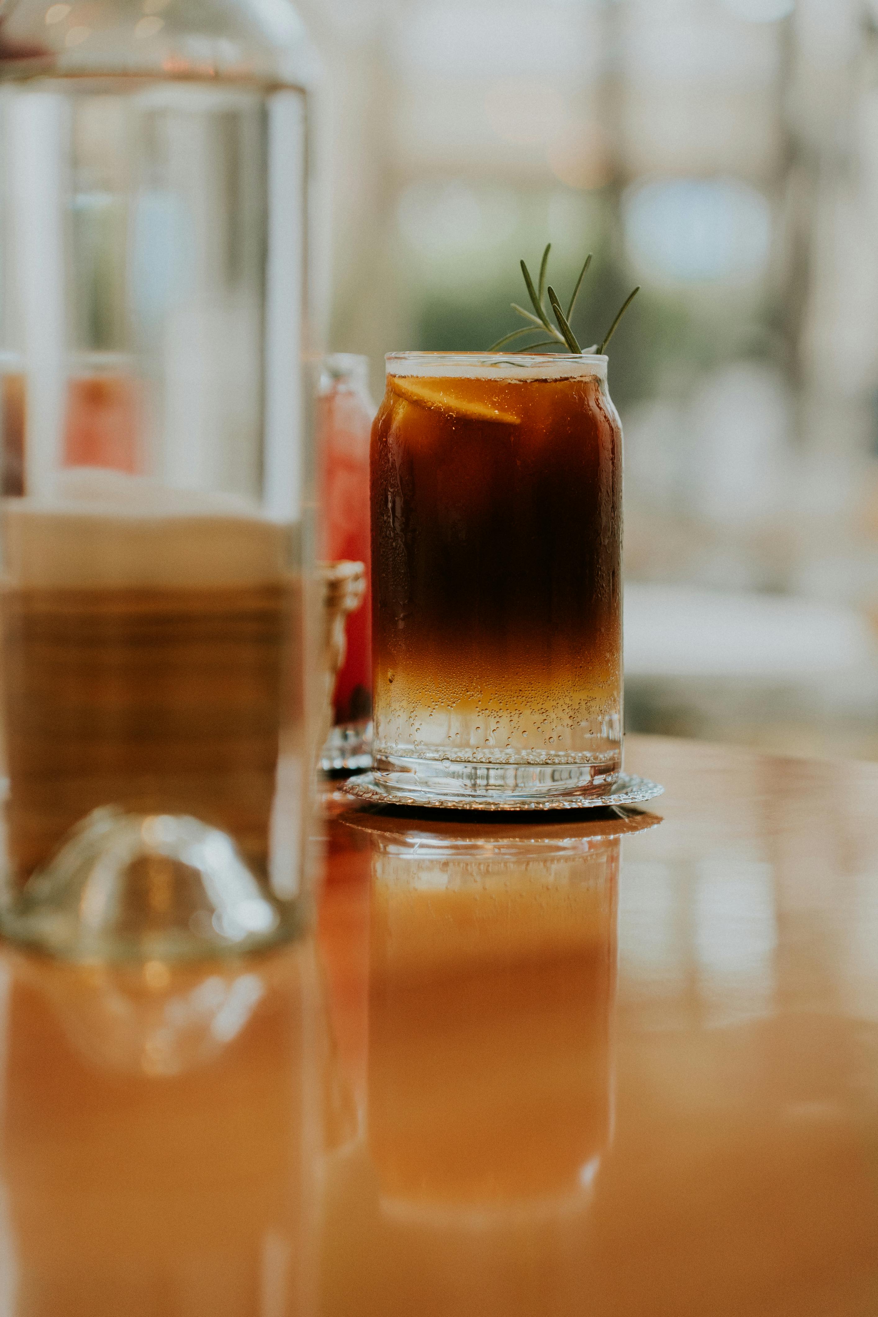 a glass of iced coffee sits on a table