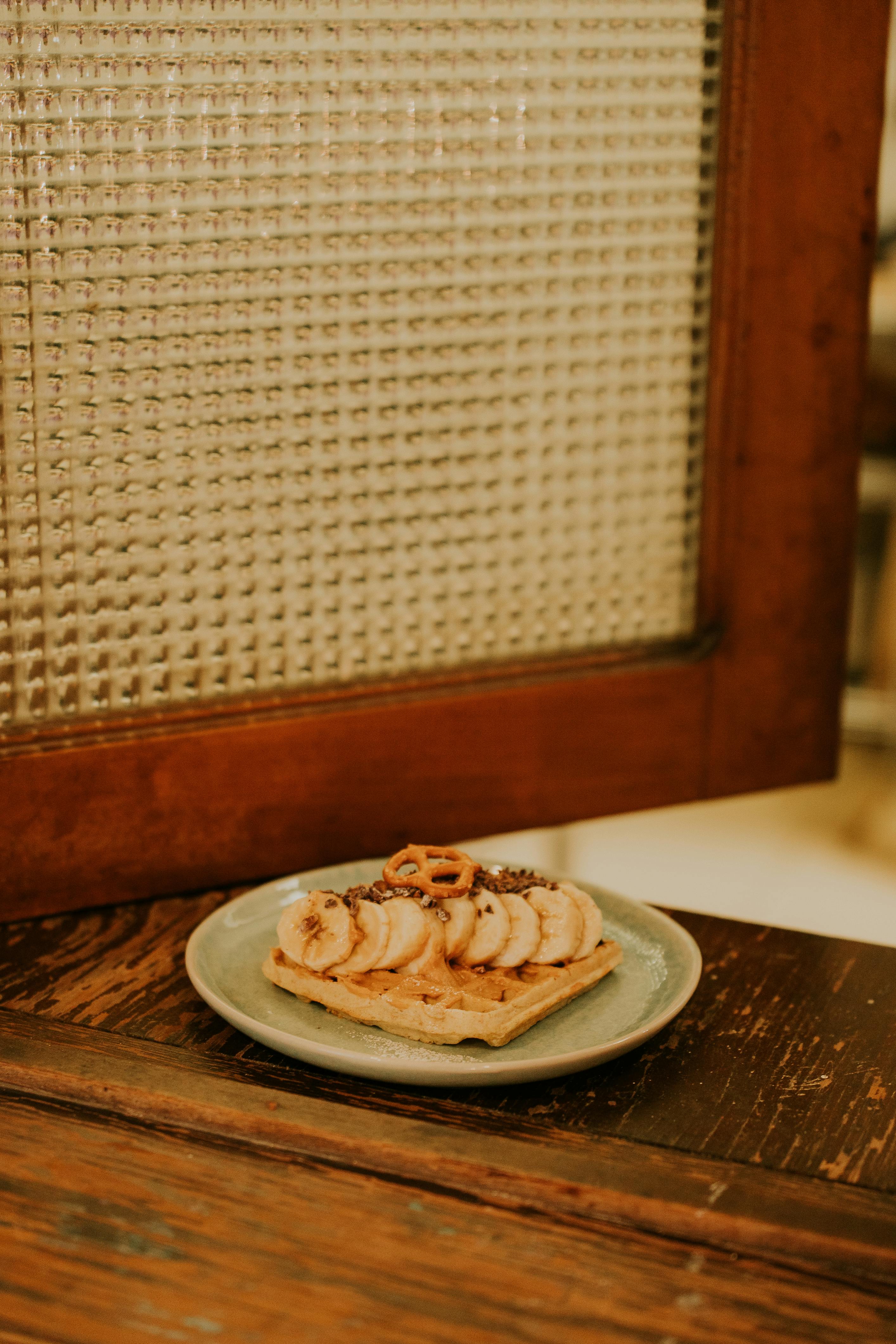 a plate of food on a table next to a window